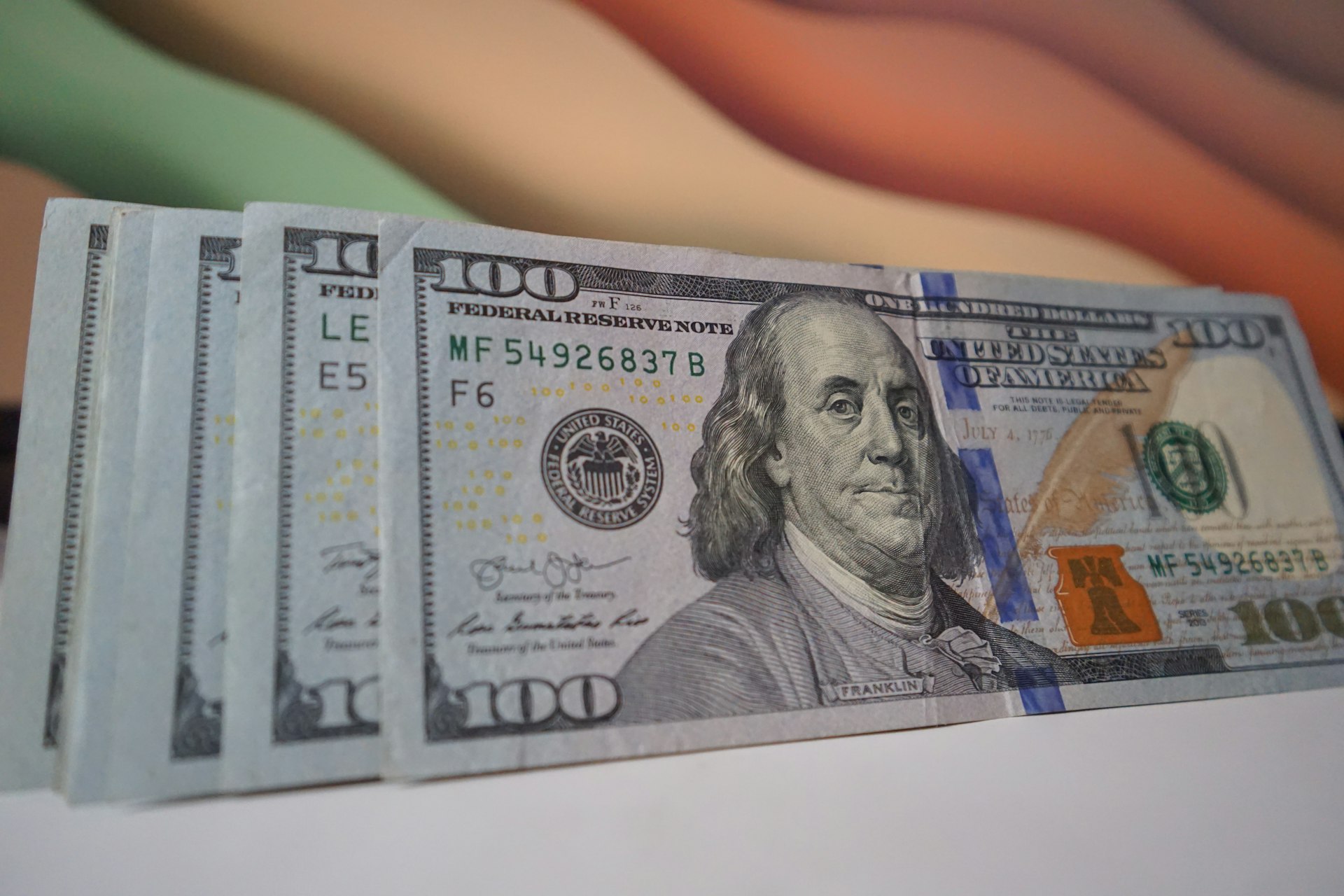 a stack of twenty dollar bills sitting on top of a table